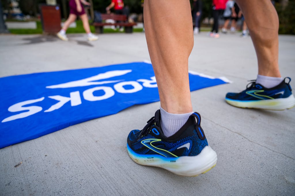 Close-up of a runner's shoes by a branded mat in Istanbul park.